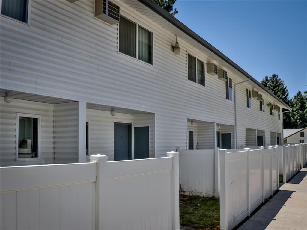 a white house with a white fence in front of it