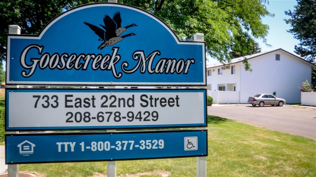 a blue sign that reads and a street