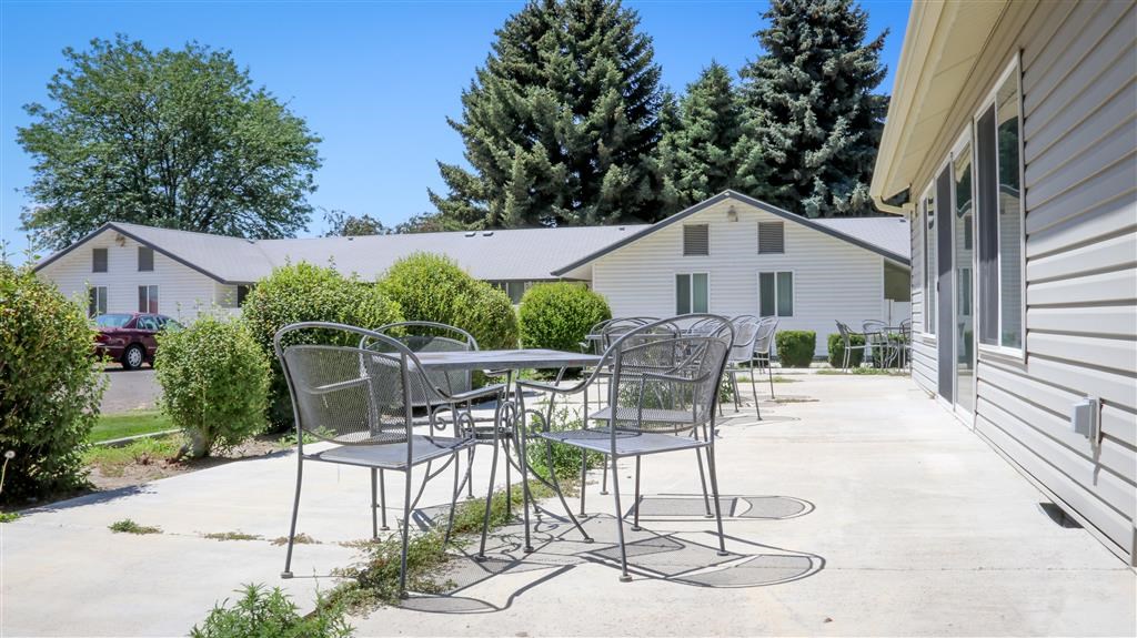 a patio with chairs and a table on a patio