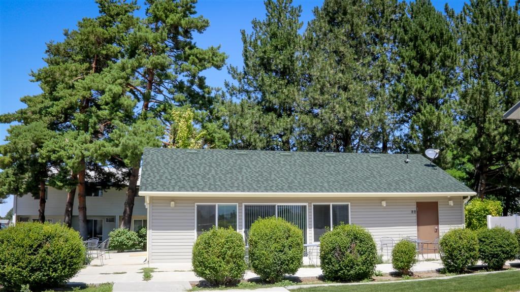 a small white house with a green roof