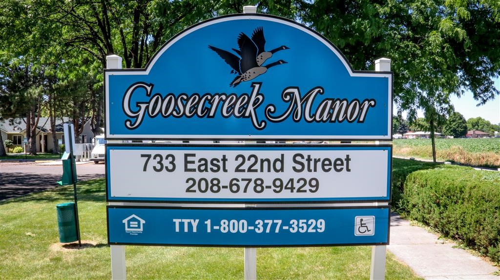 a blue sign that reads with a bird on it