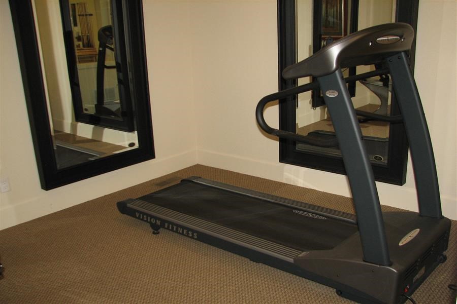 a treadmill in front of a mirror in a room