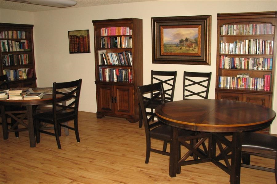 a dining room with a table and chairs and a library
