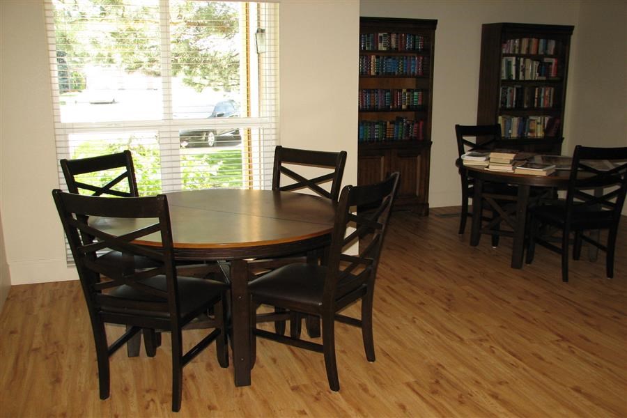 a dining room with a table and chairs and a window