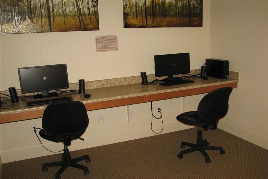 a desk with two computer monitors on it