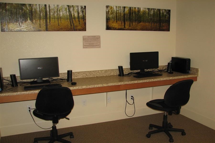 a desk with two computer monitors on it