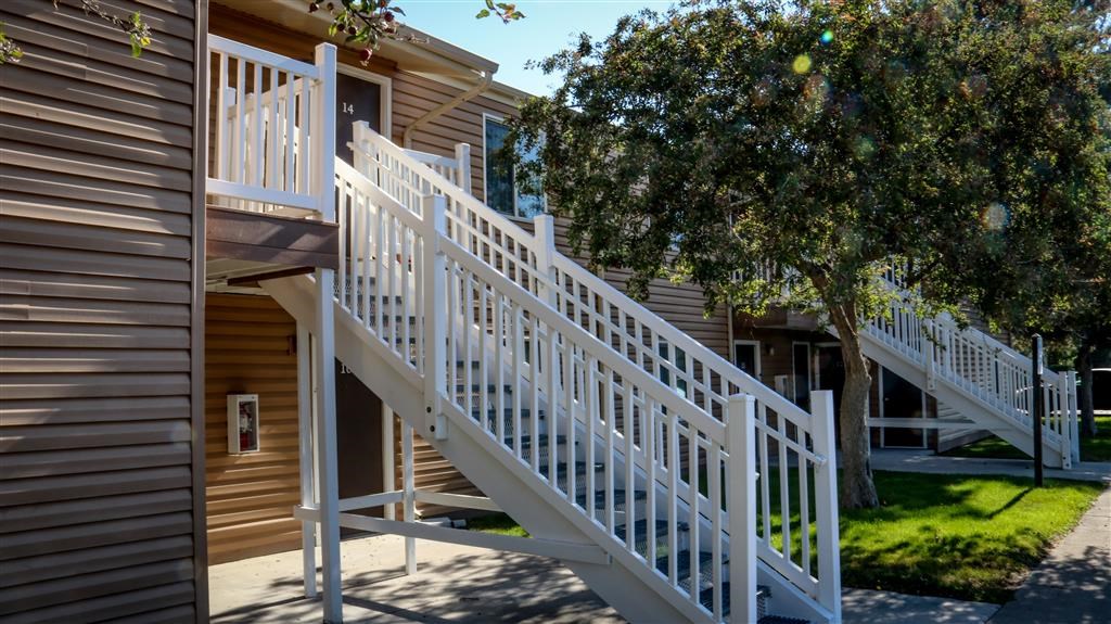a pair of white stairs in front of a house