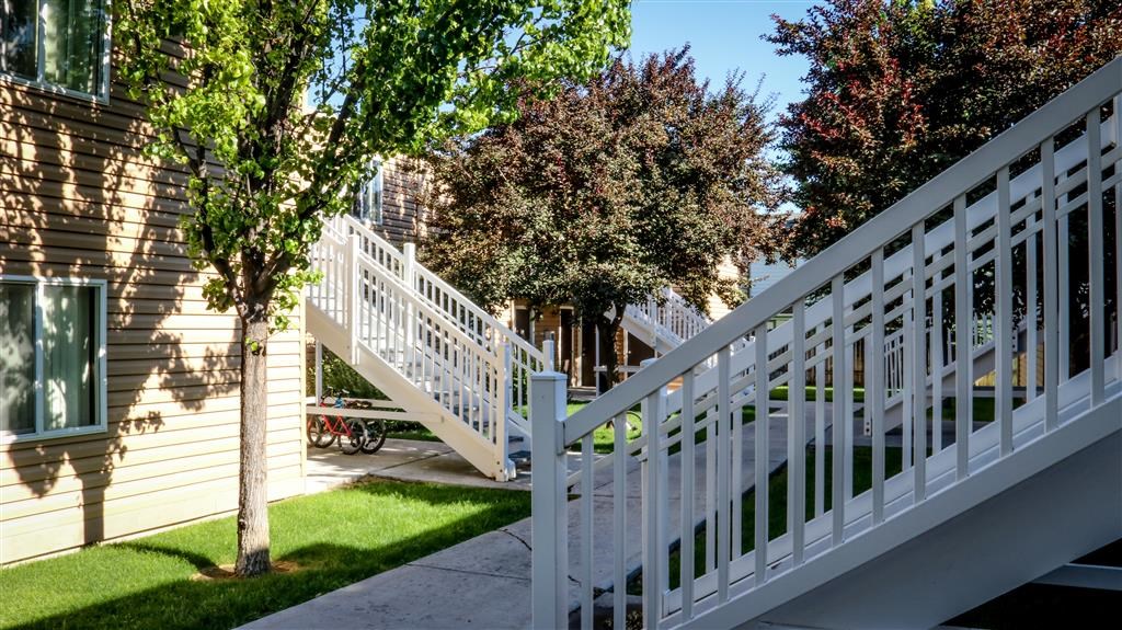 a white fence in front of a house with stairs