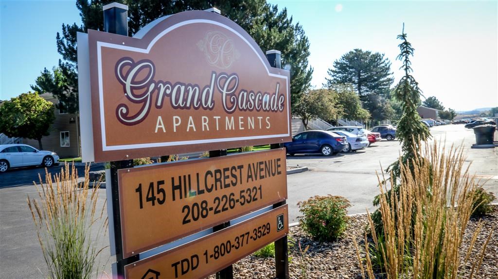 a sign for a gourmet restaurant in a parking lot