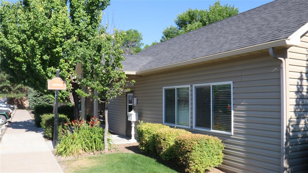 a gray house with a sign in front of it