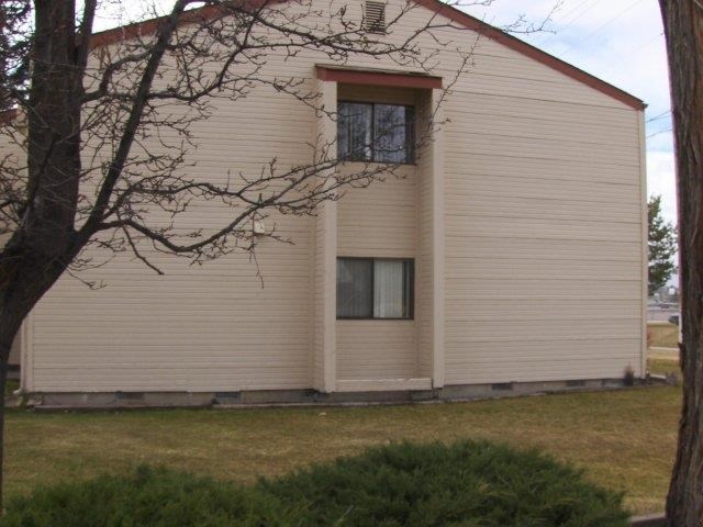 the side of a white church with a window