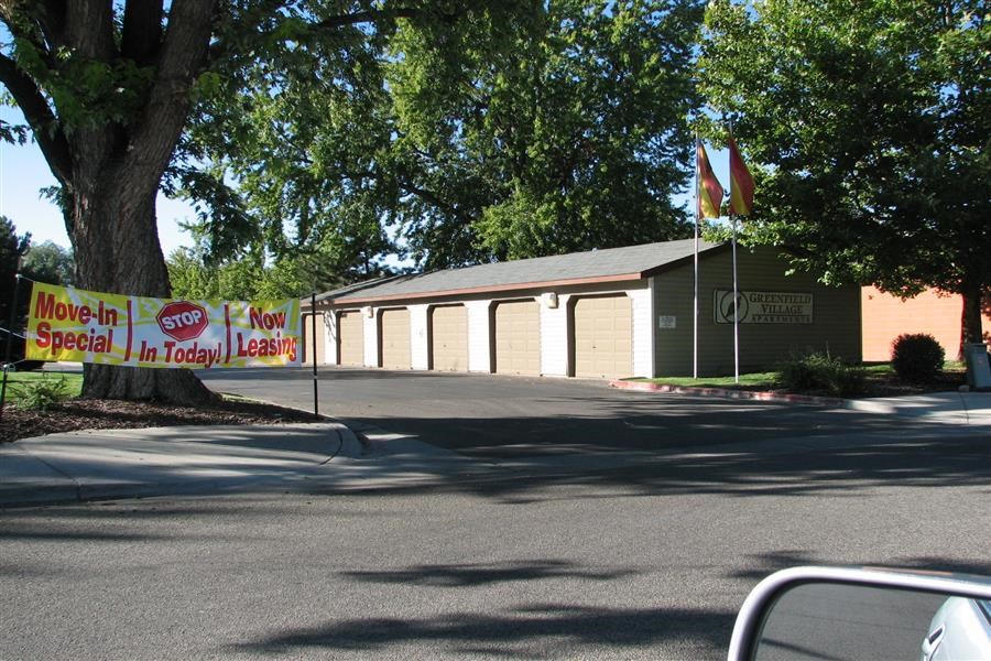 a parking lot with a sign in front of a building