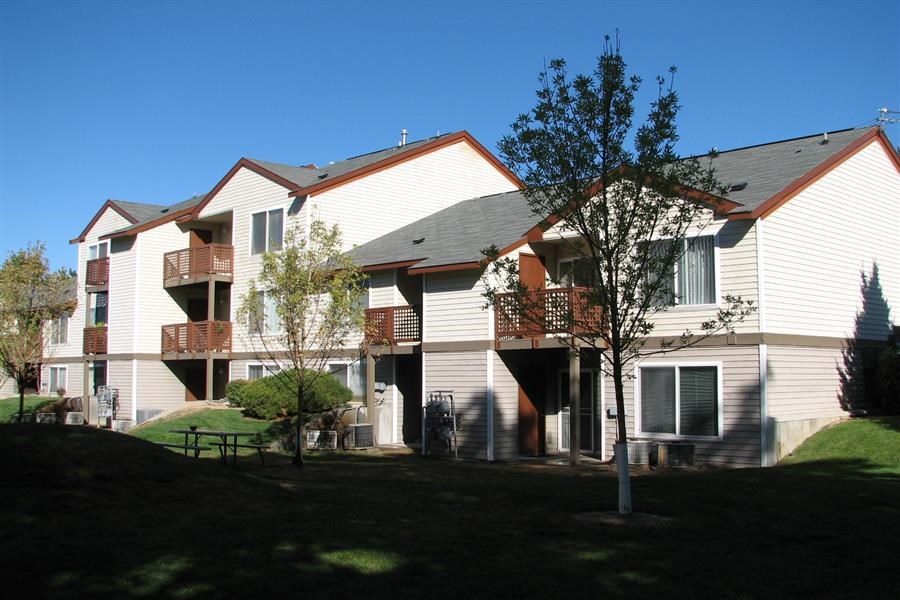 a group of houses with trees in front of them