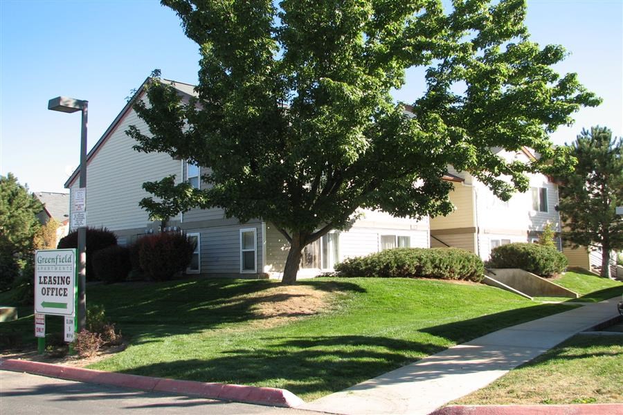 a white house with a tree in front of it