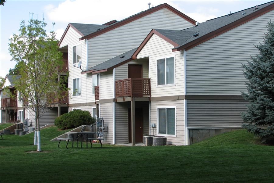 a white house with a table and chairs in the yard