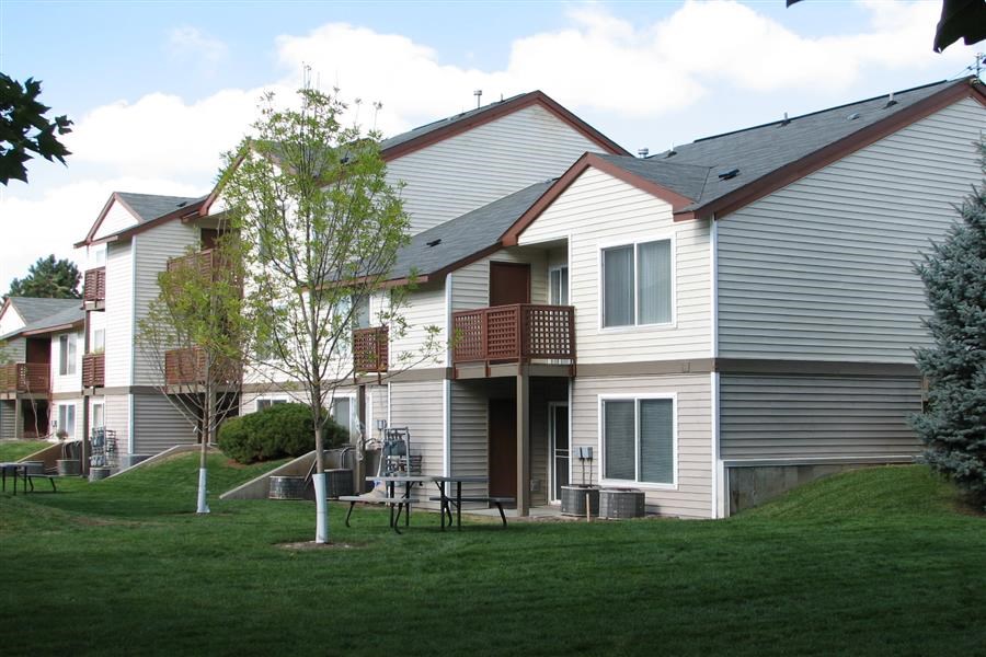 a white house with a table and chairs in the yard