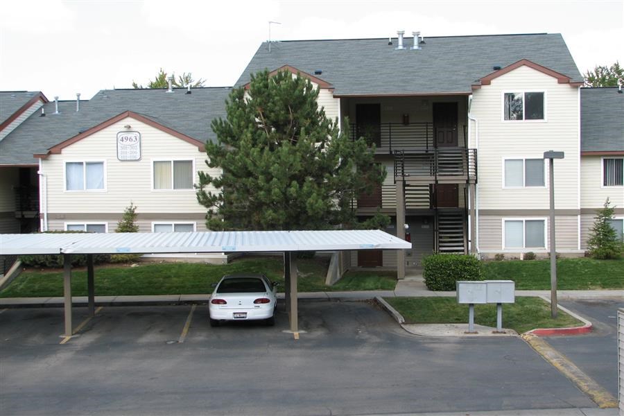 a white car parked in front of an apartment building