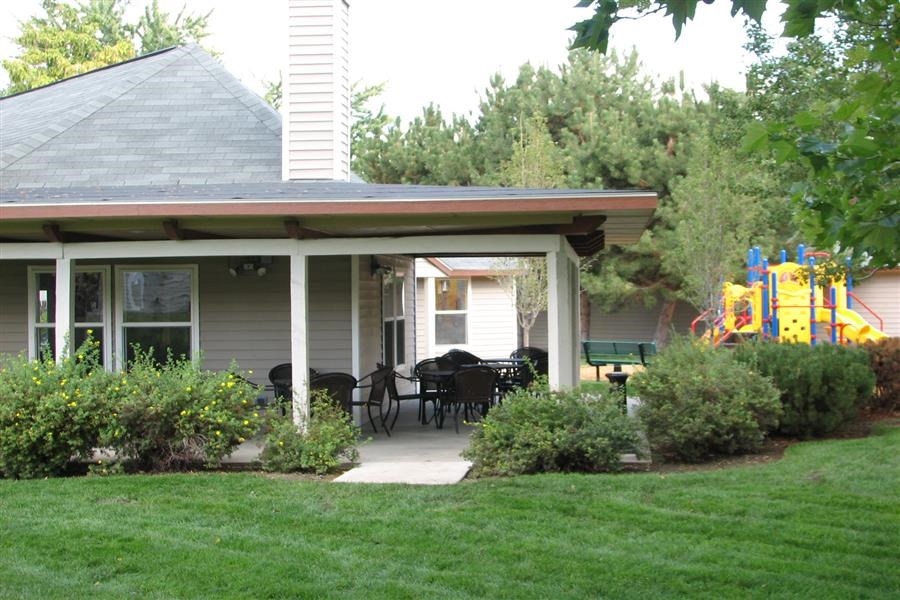 a patio with a table and chairs on a house