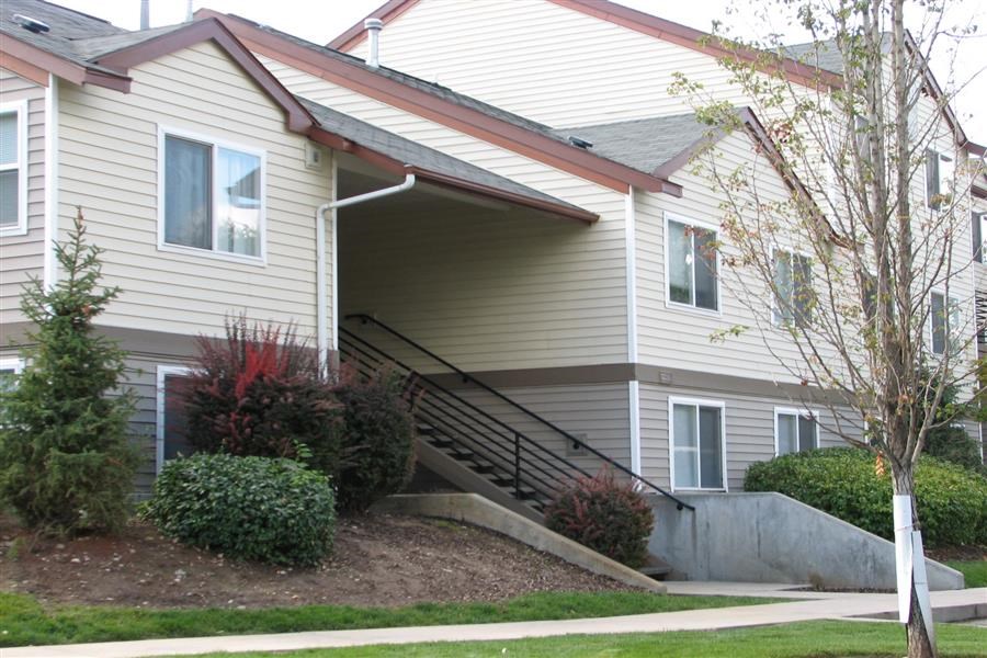 a white house with a staircase in front of it
