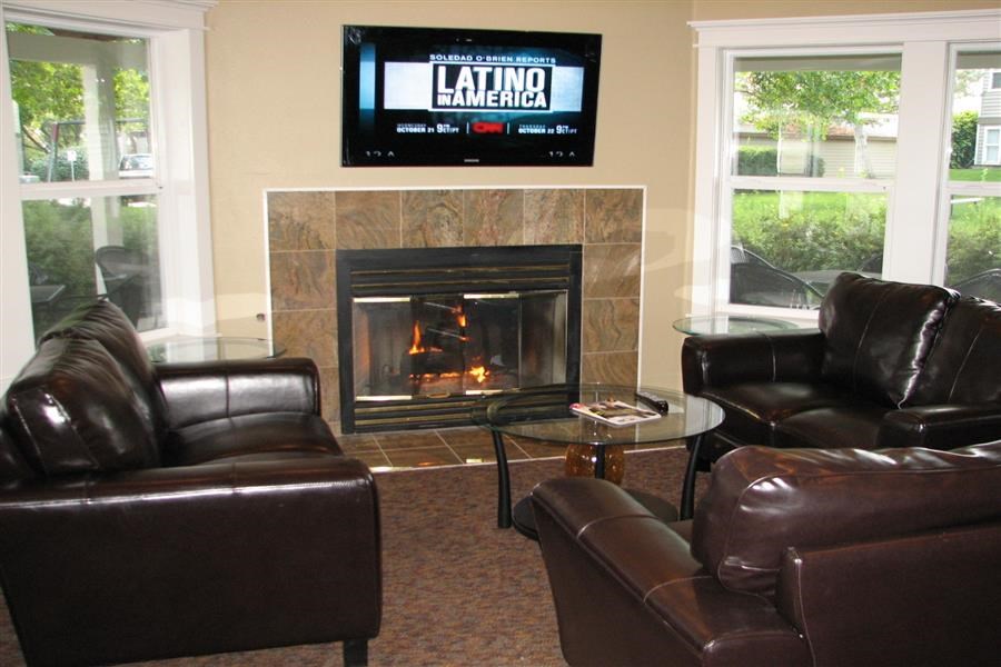 a living room with leather furniture and a fireplace