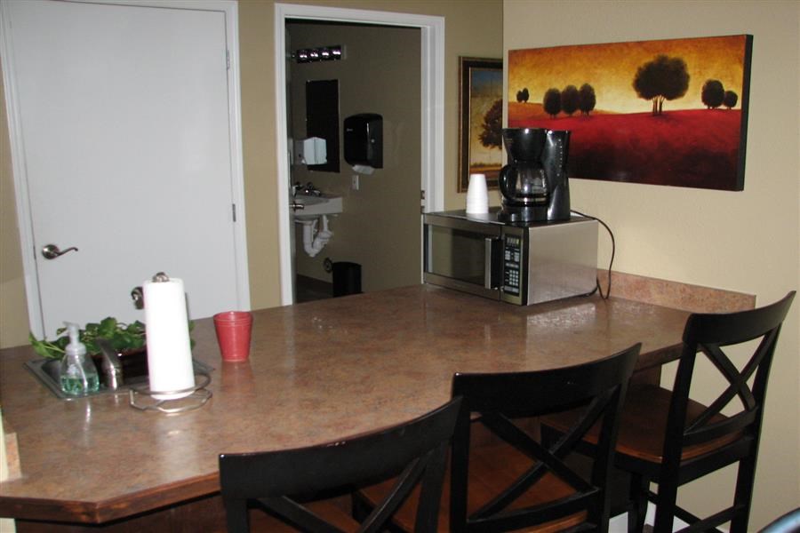 a kitchen with a table and chairs and a microwave