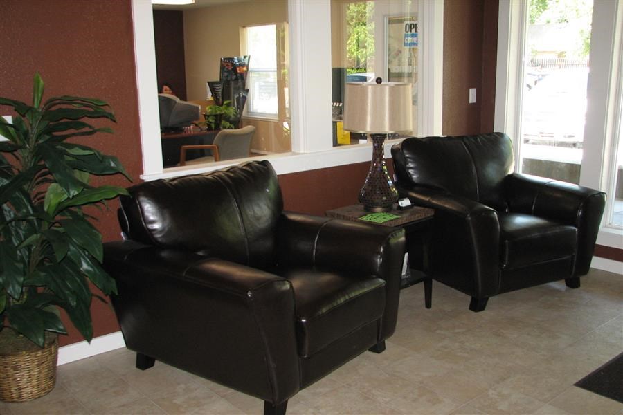 a living room with two leather chairs and a table