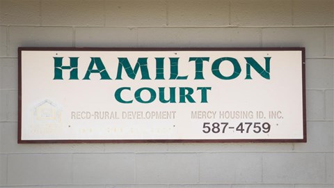 a sign for the court on the wall of a building
