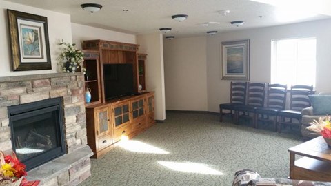 a living room with a fireplace and chairs