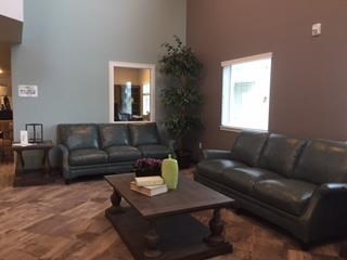 a living room with leather couches and a coffee table