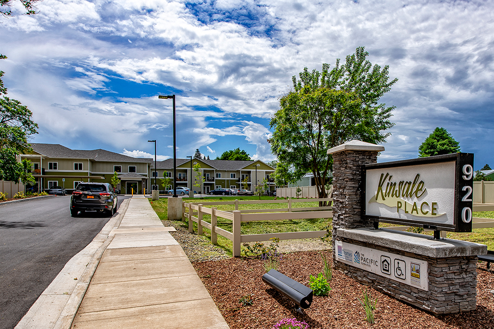 the enclave at kendra place sign at the side of a street