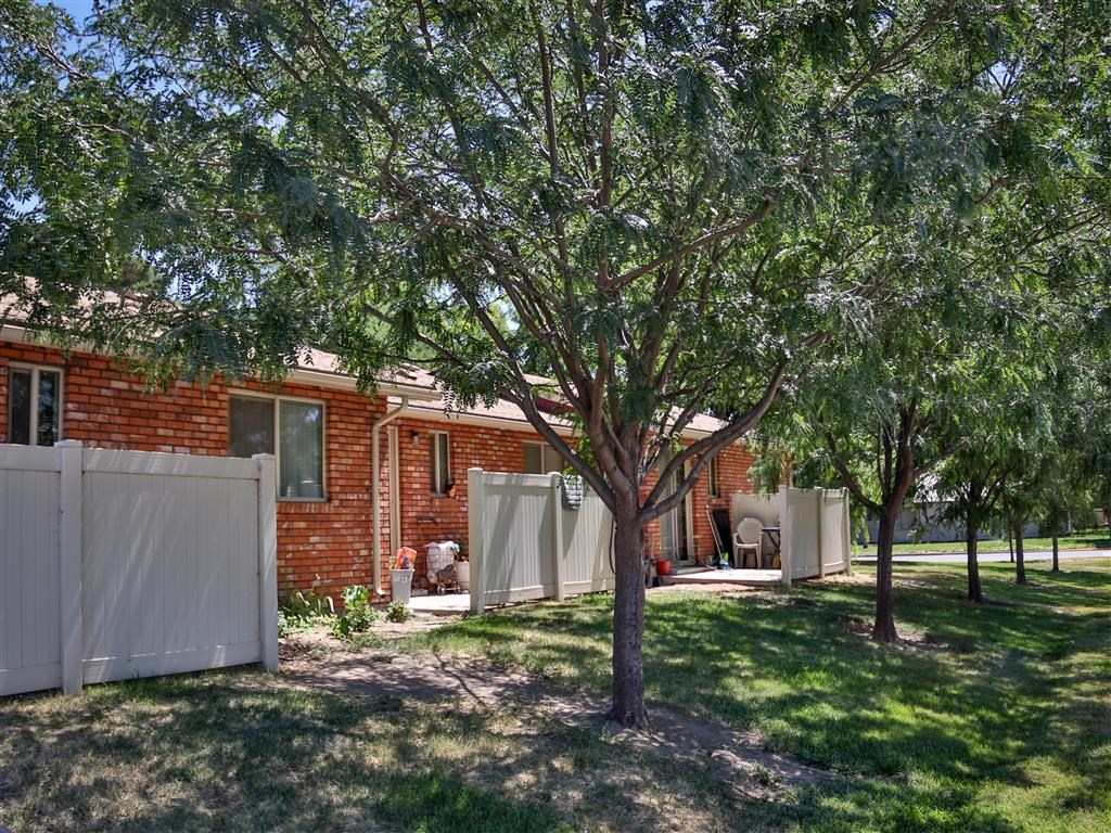 a red brick house with trees in front of it