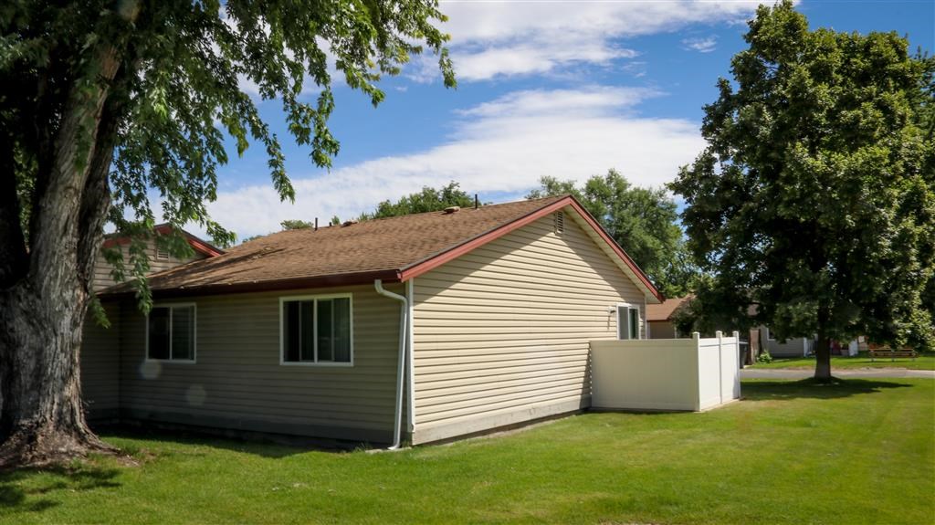 a small house with a tree in front of it