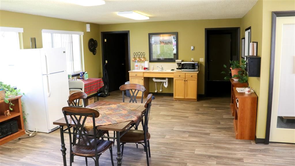 a kitchen and dining room with a table and chairs