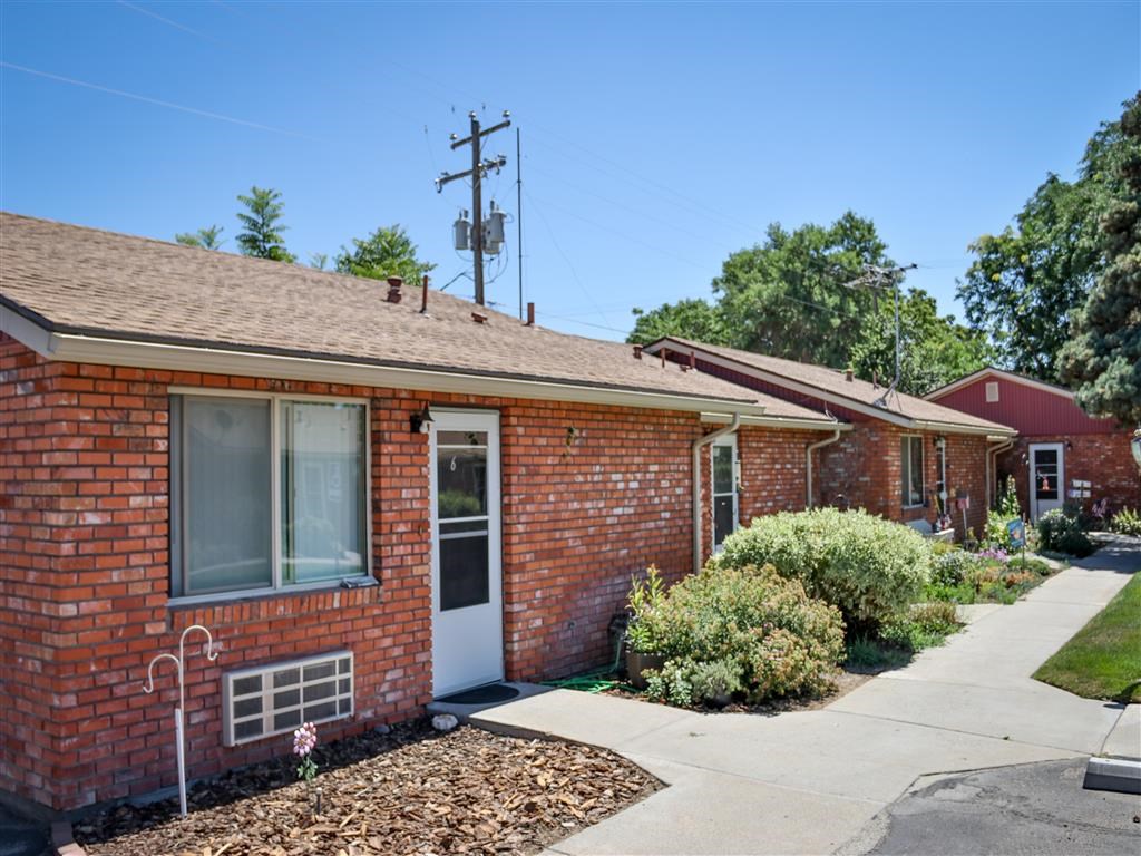 the front of a brick house with a white door