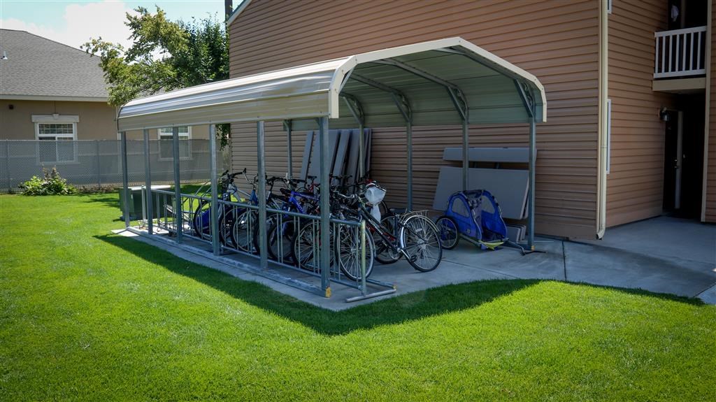 a group of bikes parked on the porch of a house