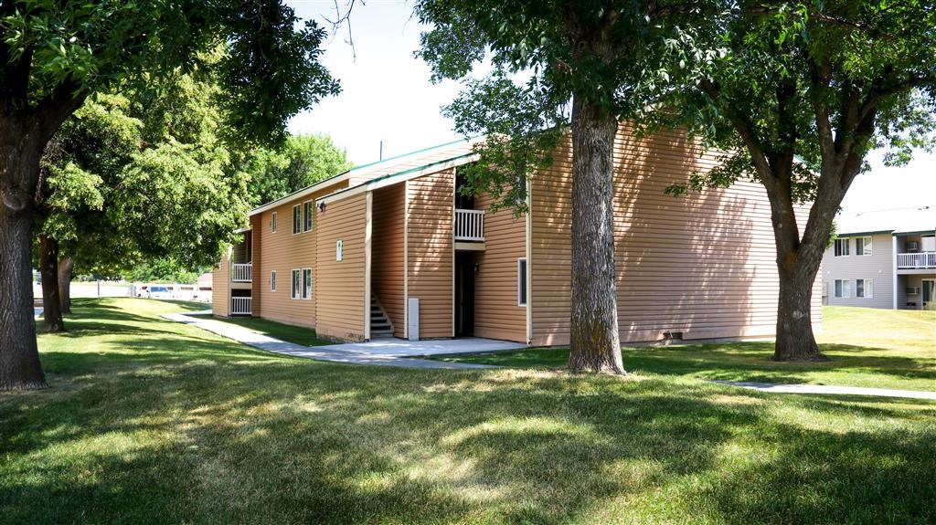 a large brown building with trees in front of it