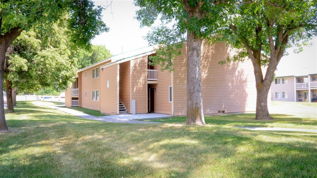 a brown building with trees in front of it