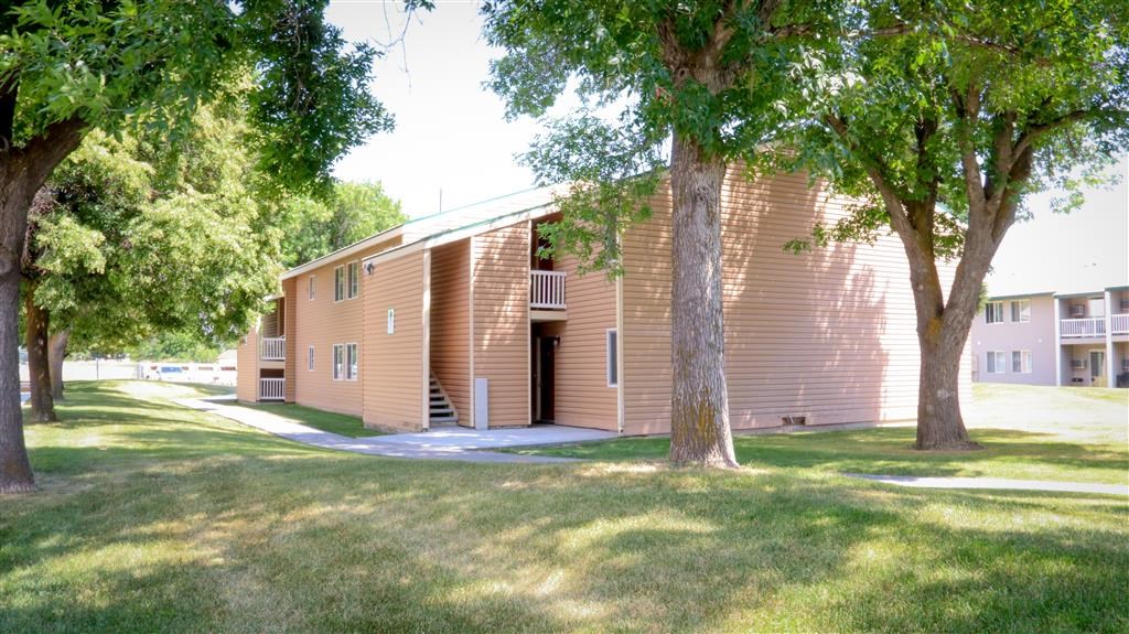 a brown building with trees in front of it