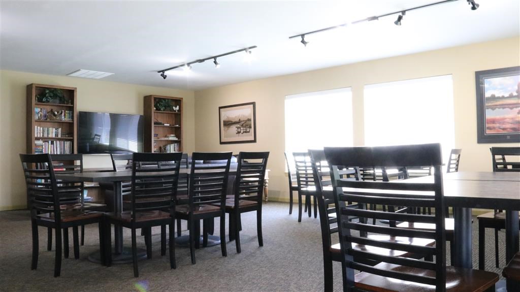 a dining room with a large table and chairs