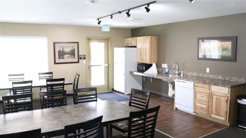 a kitchen and dining room with a table and chairs