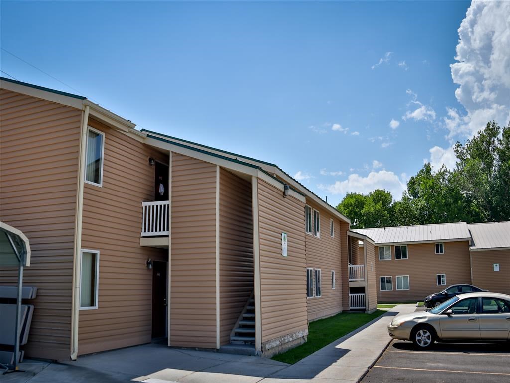 an apartment building with a car parked in front of it