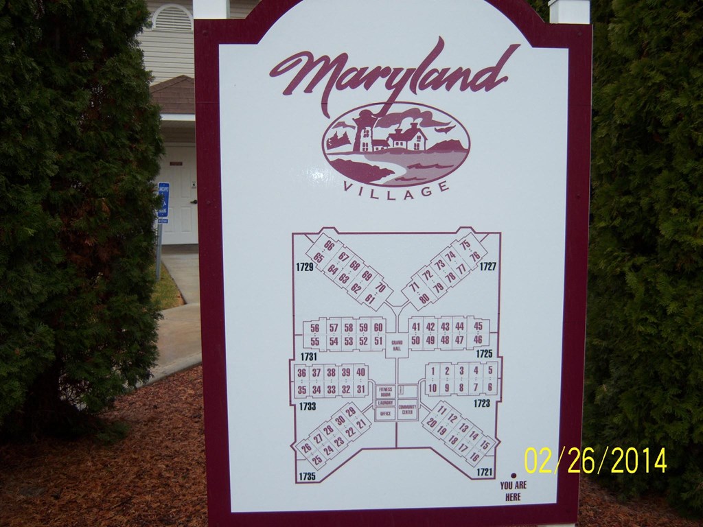 a sign for themaryland village with a game of dominoes
