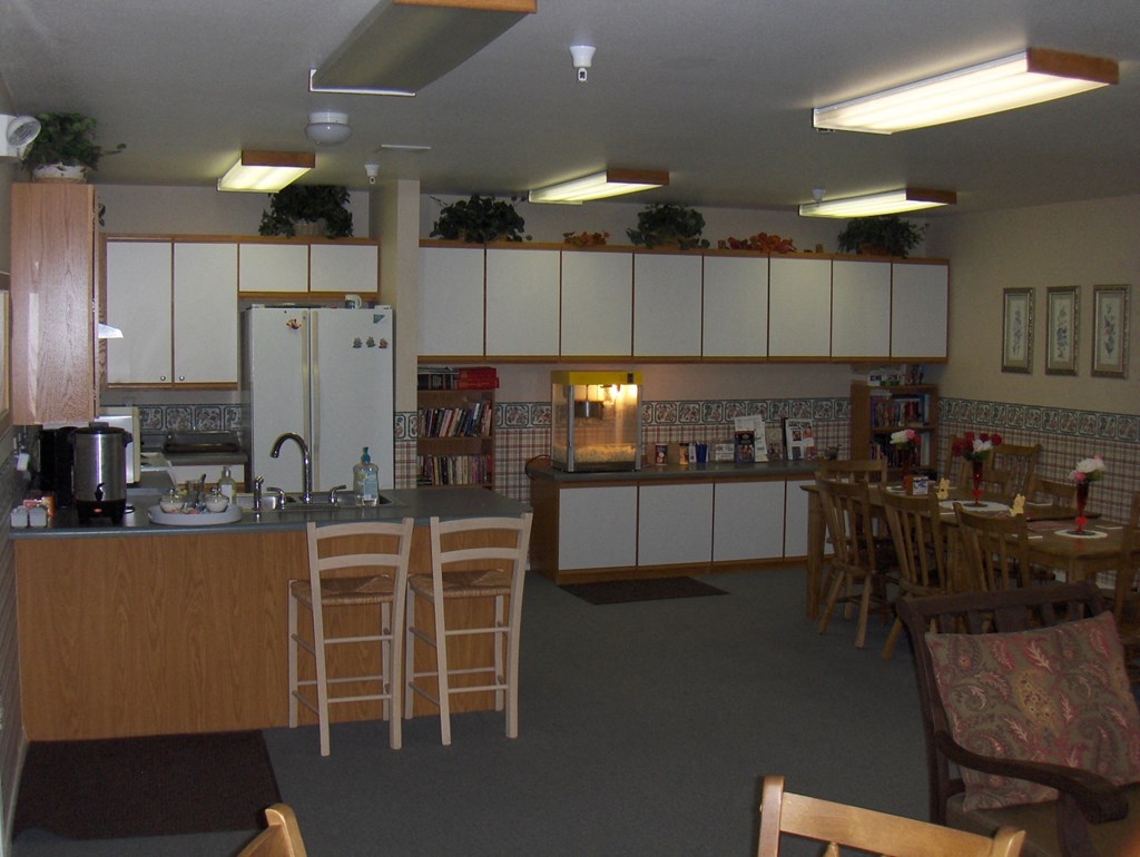 a kitchen with a table and chairs and a counter top