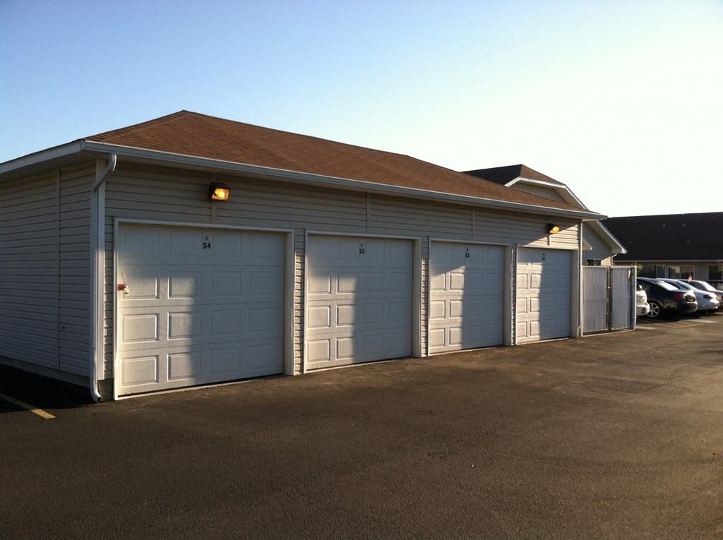 a garage with multiple garage doors on the side of a building