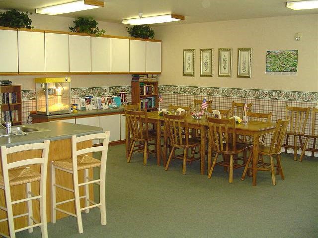 a large dining room with a table and chairs