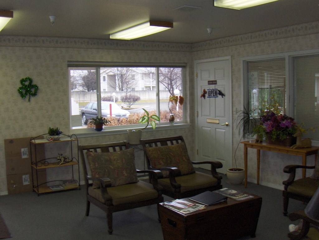 a living room filled with furniture and a large window