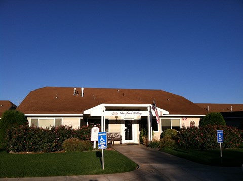 a building with a sign in front of it and a blue sky