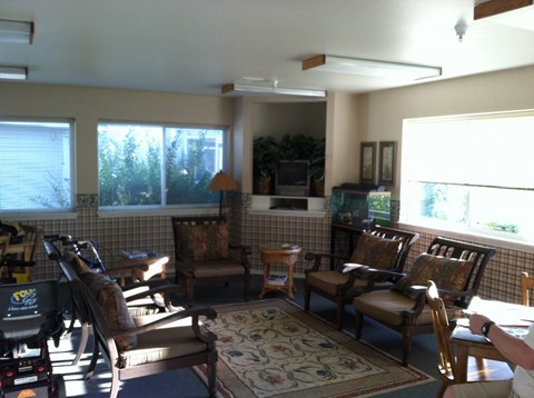 a living room filled with furniture and large windows