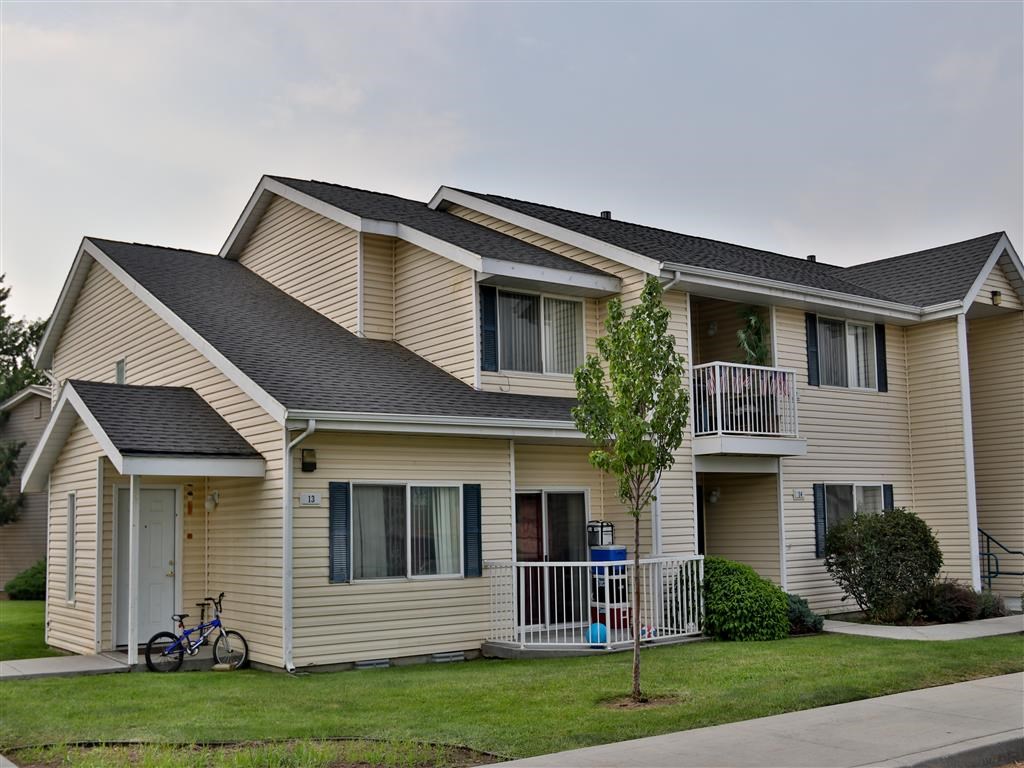 a yellow house with a bike parked in front of it