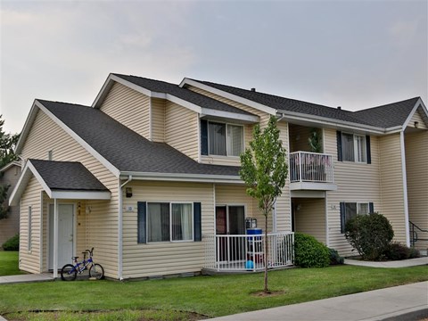 a yellow house with a bike parked in front of it